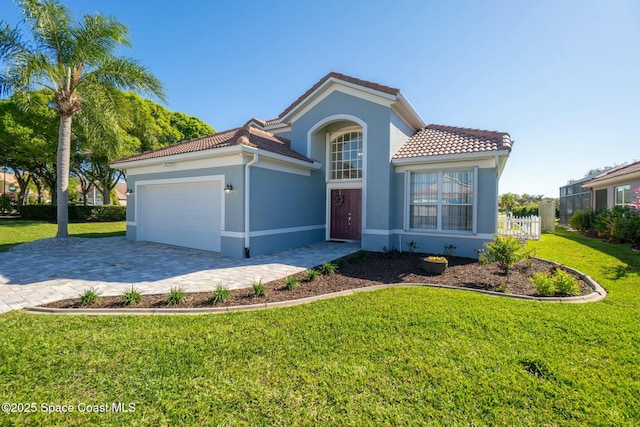 mediterranean / spanish home featuring a garage, a front yard, stucco siding, and a tile roof