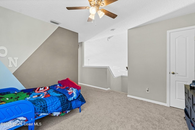 bedroom featuring carpet, baseboards, visible vents, ceiling fan, and a textured ceiling