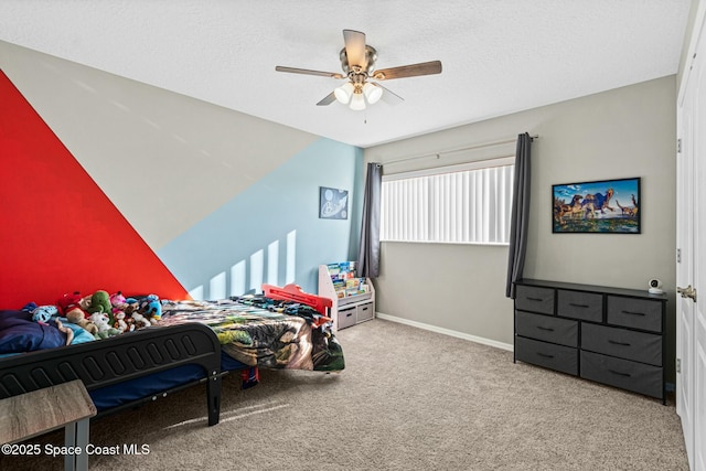 carpeted bedroom with baseboards, a textured ceiling, and ceiling fan