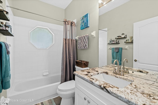 bathroom featuring toilet, vanity, and shower / bath combo