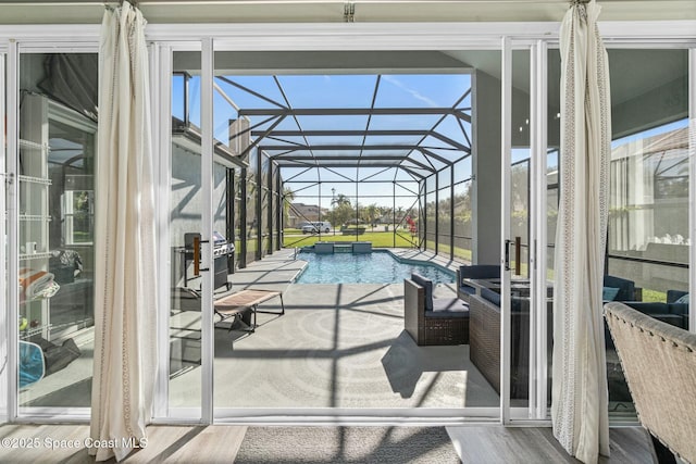 pool featuring glass enclosure, a patio, and grilling area