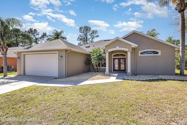 ranch-style house with french doors, a front yard, driveway, and stucco siding