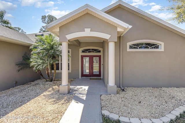 doorway to property with french doors and stucco siding