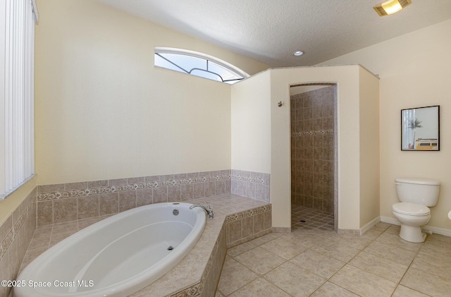 full bath featuring a bath, tiled shower, tile patterned flooring, a textured ceiling, and toilet