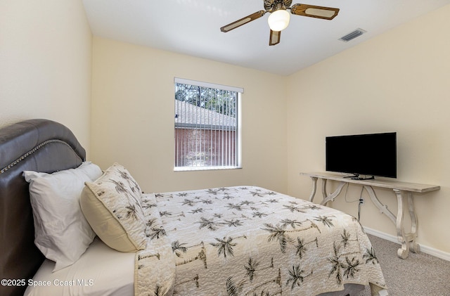 carpeted bedroom with a ceiling fan, baseboards, and visible vents