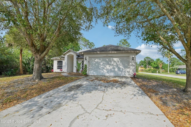 view of front facade featuring concrete driveway and an attached garage