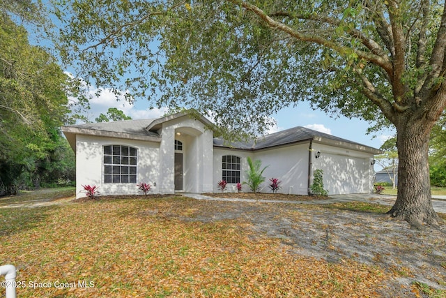 ranch-style house featuring stucco siding and an attached garage