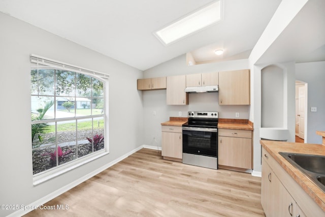 kitchen featuring under cabinet range hood, light brown cabinets, electric stove, and lofted ceiling