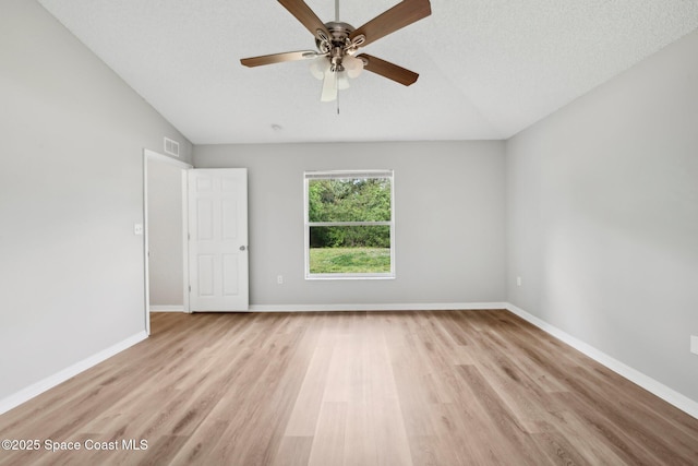 unfurnished room featuring light wood-style flooring, visible vents, baseboards, and a textured ceiling