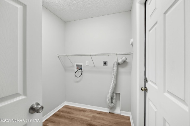 laundry area featuring wood finished floors, hookup for an electric dryer, laundry area, washer hookup, and a textured ceiling