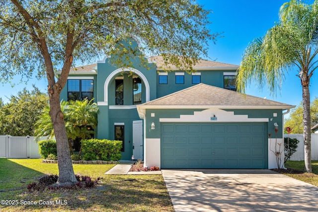 traditional home with fence, a front yard, stucco siding, driveway, and an attached garage