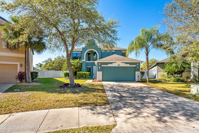 view of front of home with stucco siding, concrete driveway, a front lawn, and fence