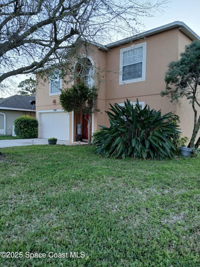 traditional-style house with stucco siding, an attached garage, concrete driveway, and a front lawn