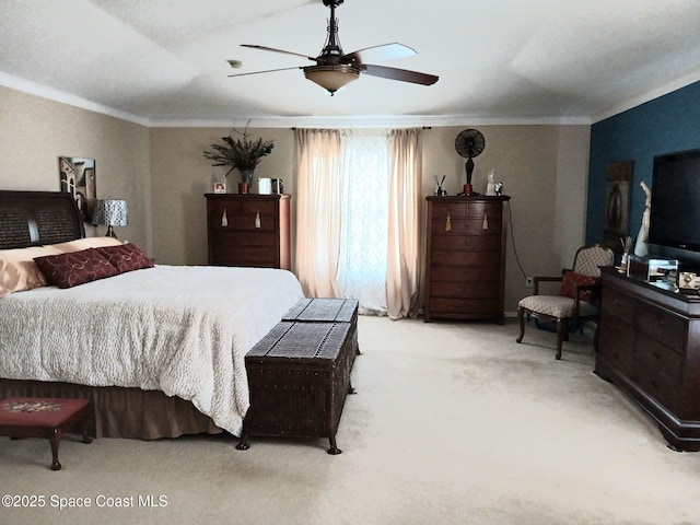 bedroom with crown molding, a ceiling fan, and carpet floors