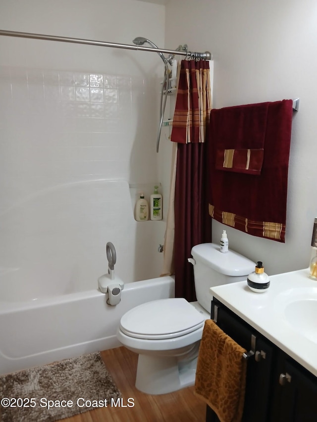 full bath with vanity, shower / tub combo, toilet, and wood finished floors