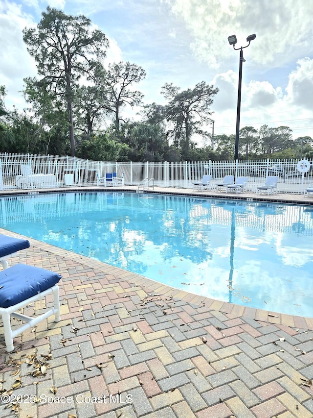 pool featuring a patio and fence