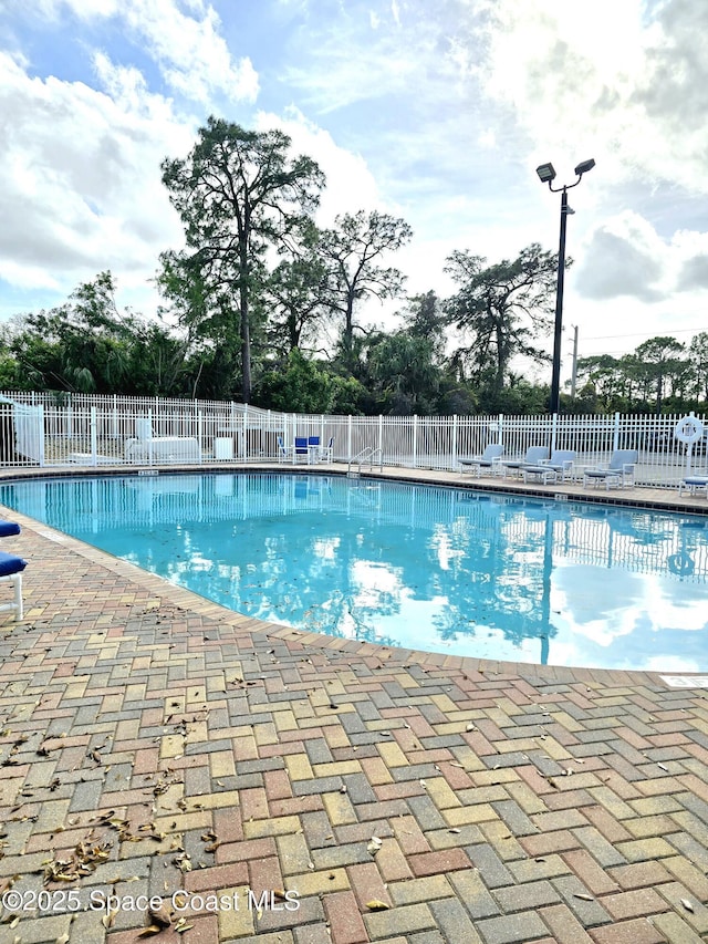 pool featuring a patio and fence