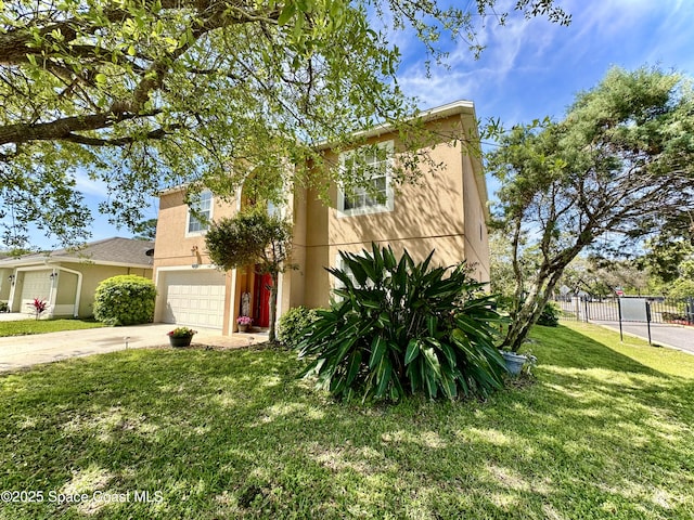 view of front of home featuring fence, a front yard, stucco siding, a garage, and driveway