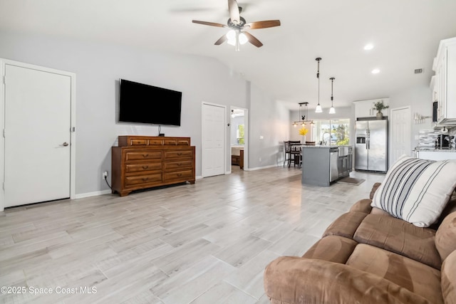 living area with recessed lighting, ceiling fan, baseboards, and lofted ceiling