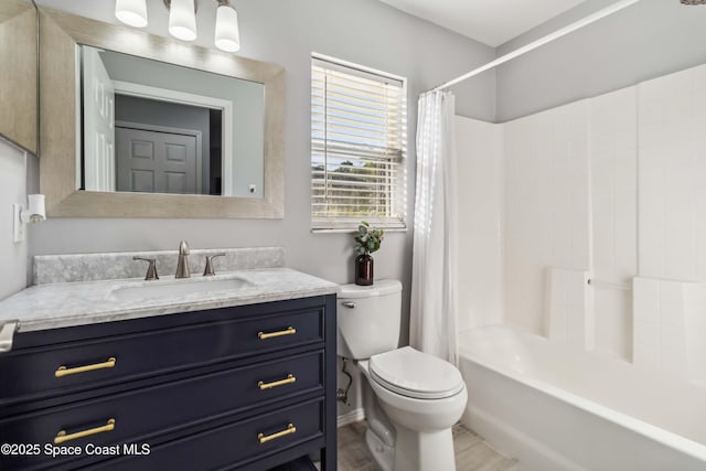 full bath featuring toilet, shower / bath combo, and vanity