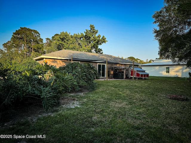 rear view of property with a yard