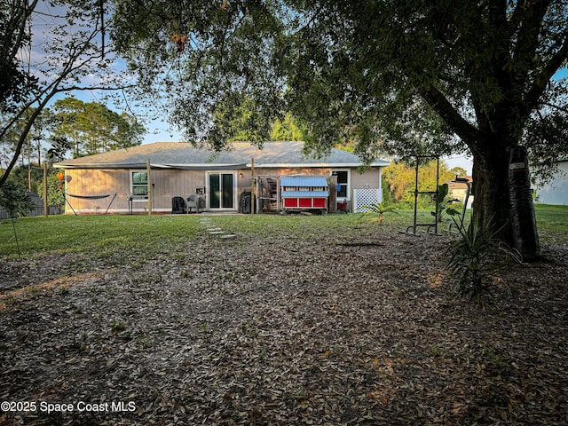 back of property with a lawn