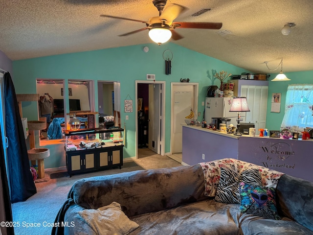 living area featuring visible vents, lofted ceiling, carpet, and a textured ceiling