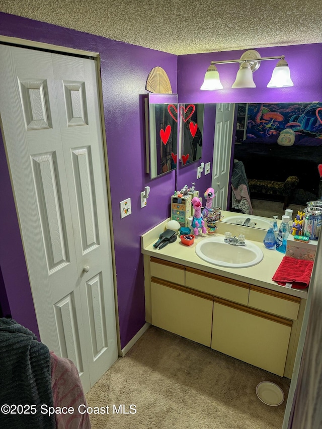 bathroom featuring a textured ceiling and vanity