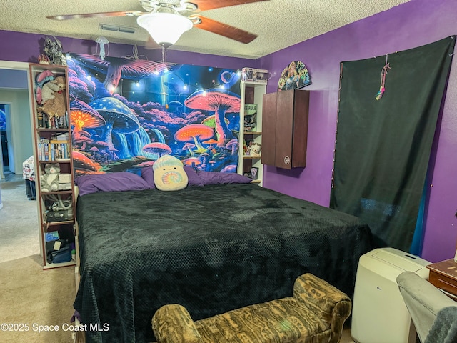 bedroom with ceiling fan, carpet, visible vents, and a textured ceiling