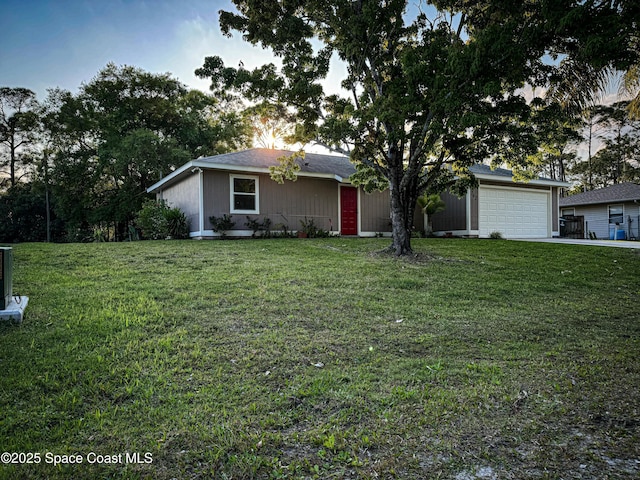 view of front facade with a garage, concrete driveway, and a front lawn