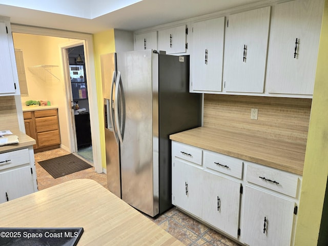 2001 Villa Espana Trl, Melbourne, FL 32935 - kitchen featuring light countertops and stainless steel fridge