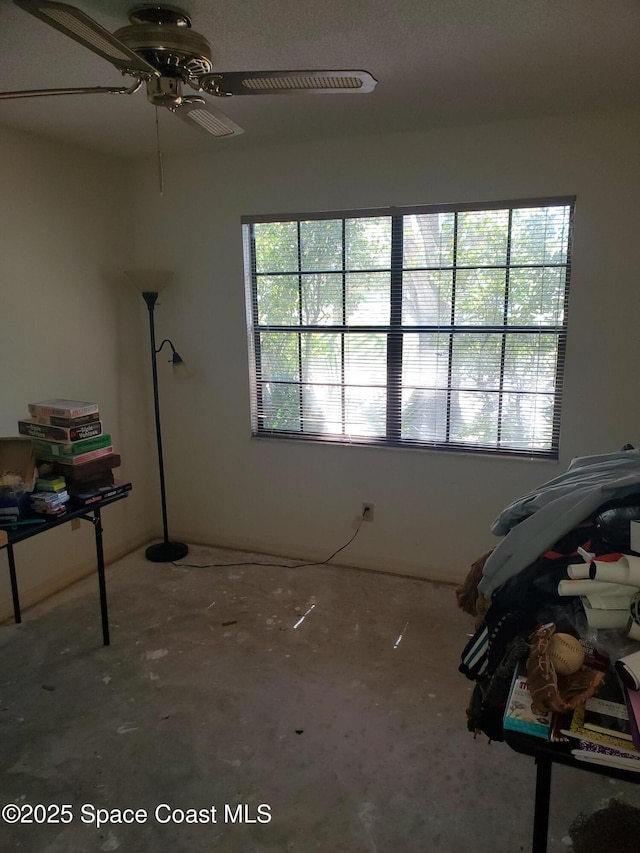 interior space with ceiling fan