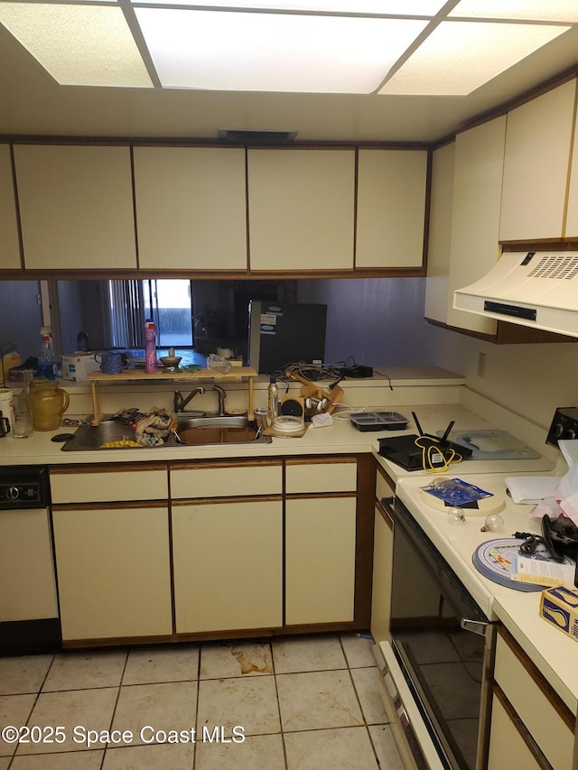 kitchen featuring range with electric stovetop, ventilation hood, light countertops, and white dishwasher