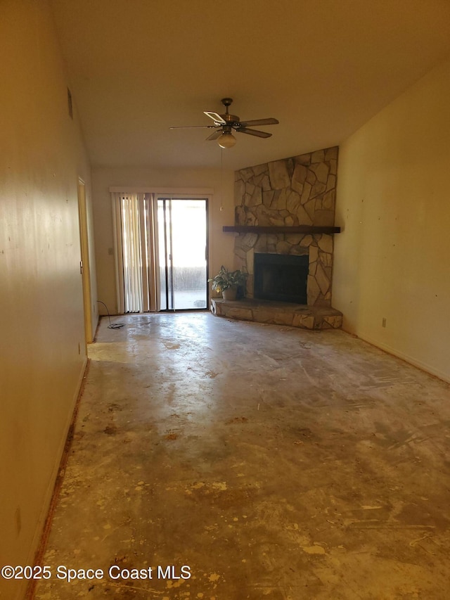 unfurnished living room with a fireplace, lofted ceiling, unfinished concrete flooring, and a ceiling fan