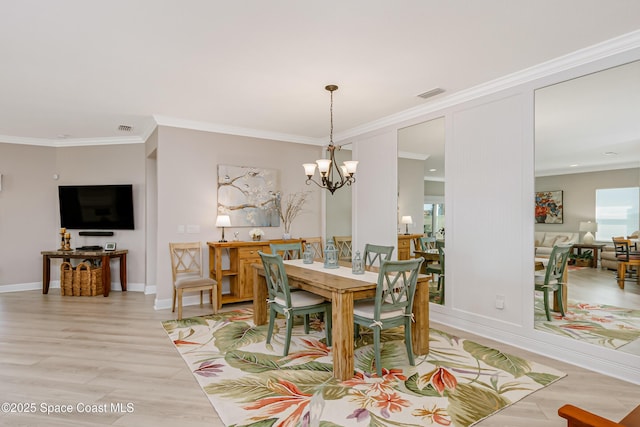 dining space with visible vents, light wood finished floors, and ornamental molding