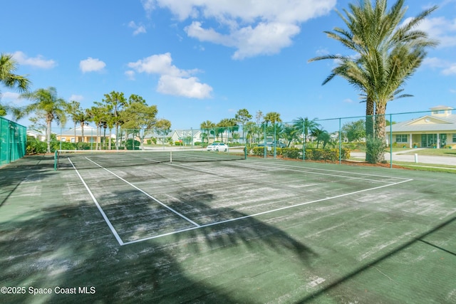 view of tennis court featuring fence