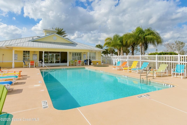 community pool featuring a patio and fence