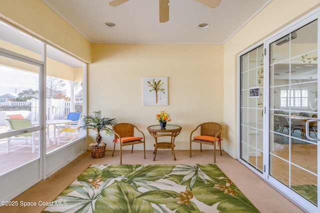 sunroom / solarium featuring ceiling fan