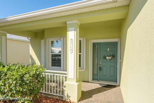 view of exterior entry featuring stucco siding