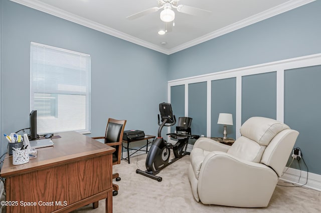 office space featuring crown molding, a decorative wall, a ceiling fan, and light carpet