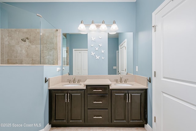 full bathroom featuring double vanity, walk in shower, and a sink