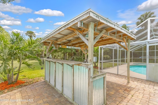 pool featuring a patio area and glass enclosure