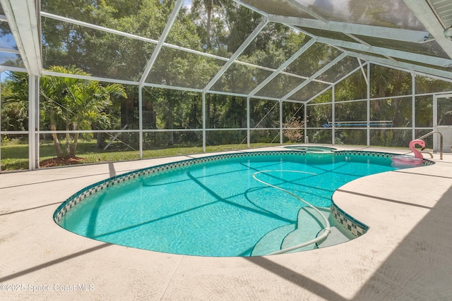 outdoor pool with a patio area, glass enclosure, and an in ground hot tub