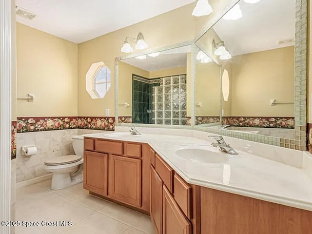 bathroom with tile patterned floors, visible vents, toilet, and a sink