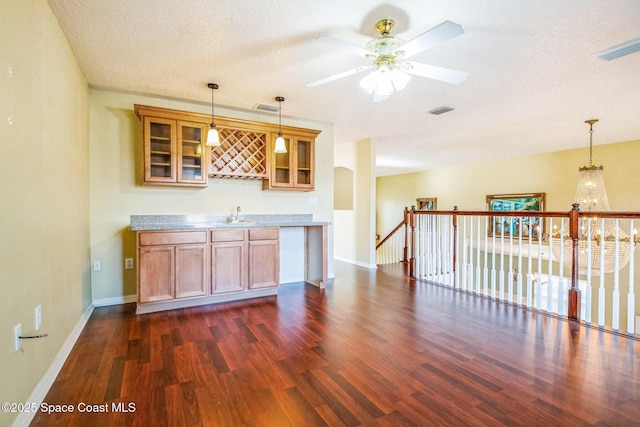 bar featuring visible vents, dark wood finished floors, ceiling fan, hanging light fixtures, and indoor wet bar