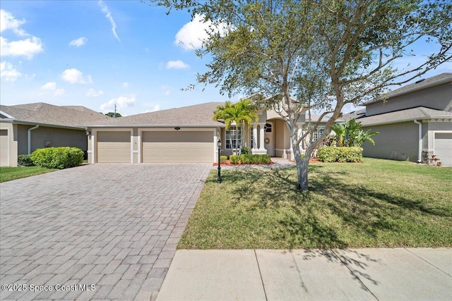 ranch-style house featuring stucco siding, a front yard, decorative driveway, and a garage