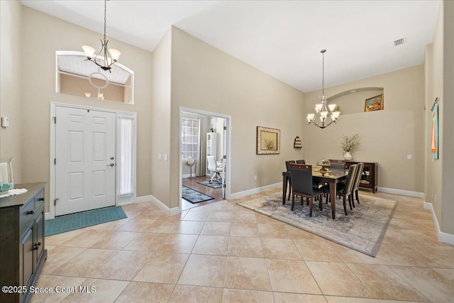 dining area featuring a notable chandelier, baseboards, and visible vents