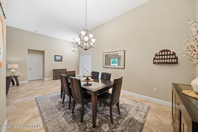 dining room with light tile patterned flooring, a notable chandelier, high vaulted ceiling, and baseboards