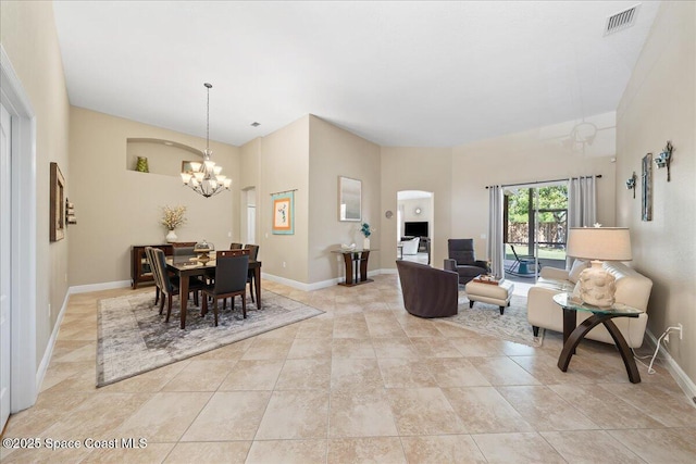 dining room with light tile patterned floors, visible vents, baseboards, and a chandelier