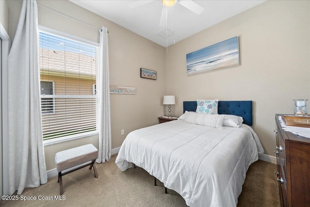 bedroom with ceiling fan, baseboards, and carpet floors